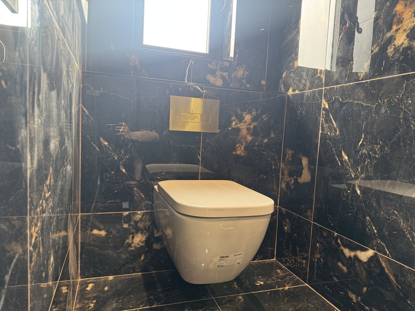 Matching wall-hung WC with a concealed cistern for a seamless, modern look.