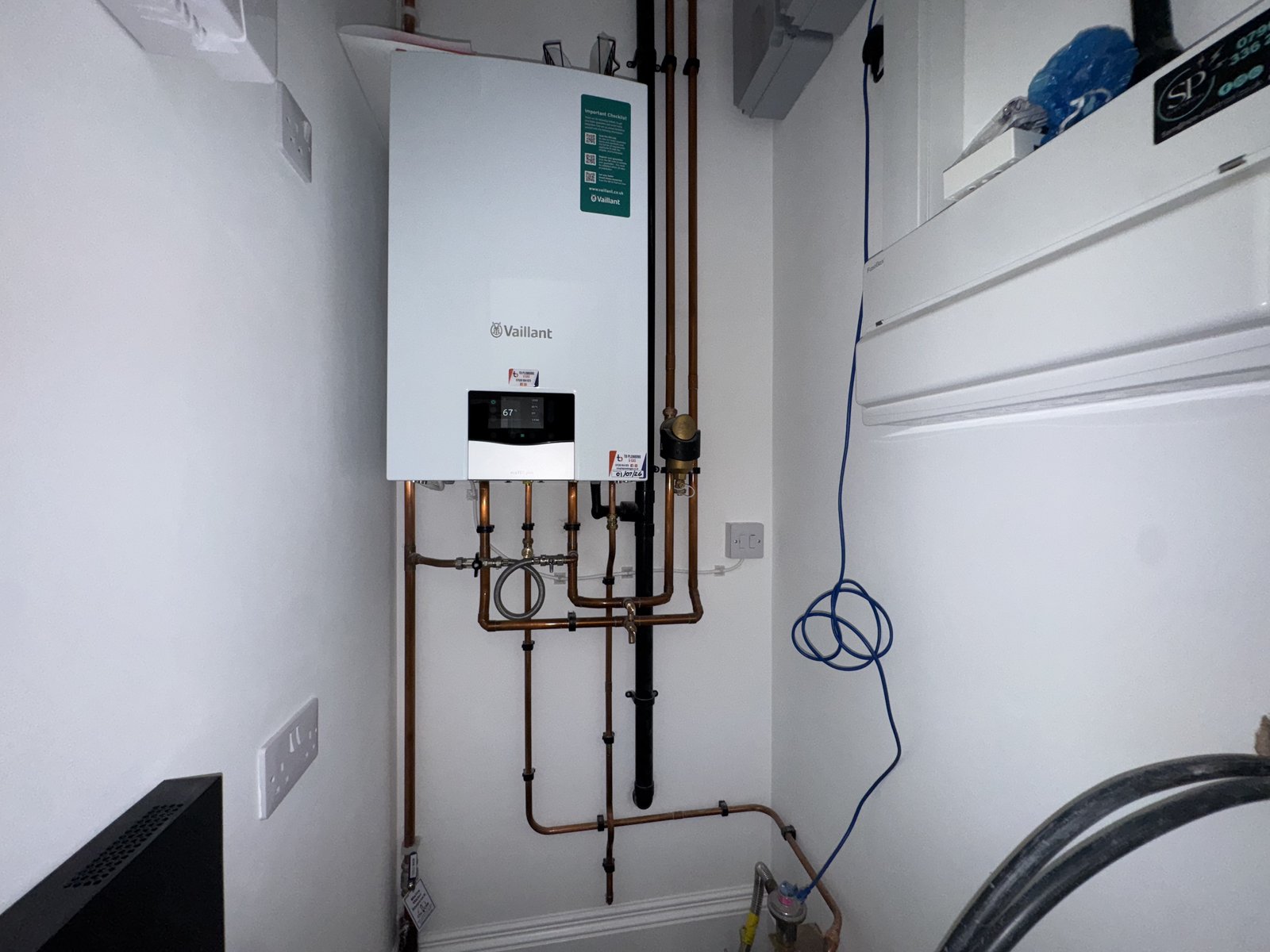 A new wall-mounted combi boiler with tidy copper pipework and a filling loop.