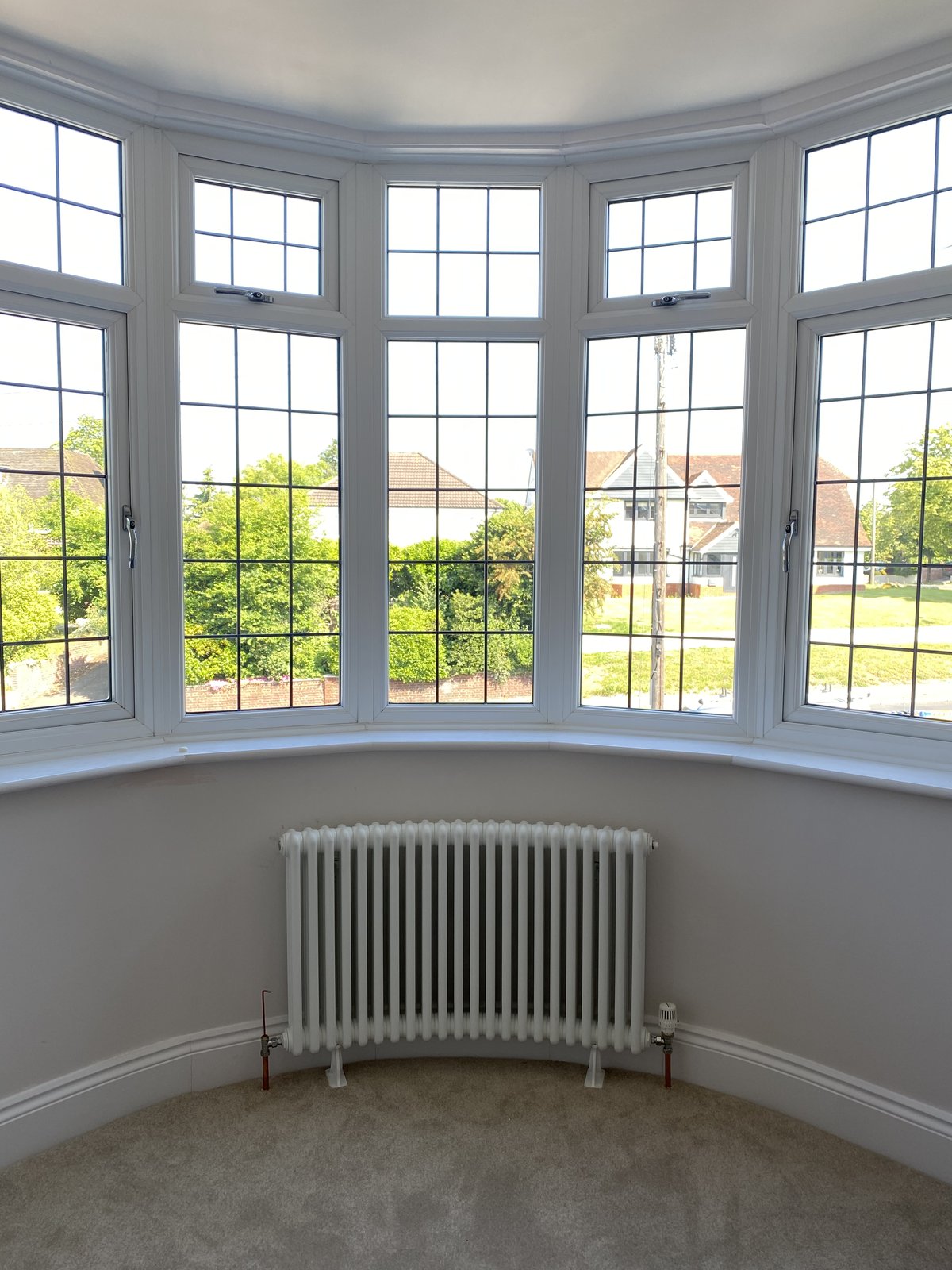Column radiator sited neatly beneath a bay window.